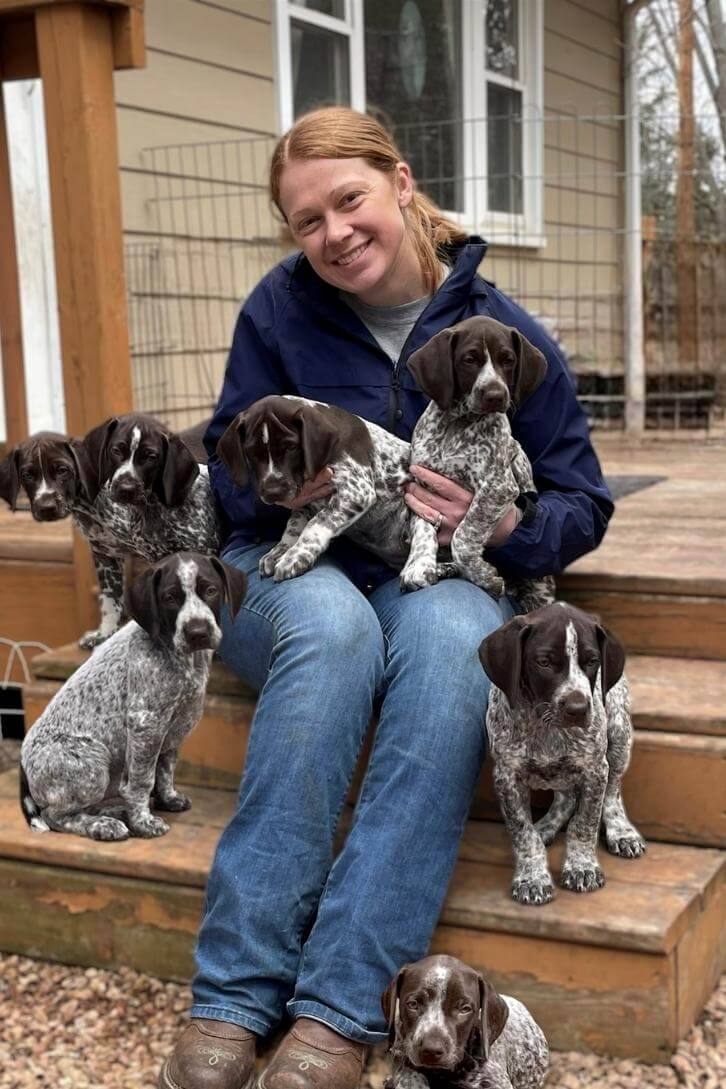 Dr Wiberg with a half dozen adorable puppies